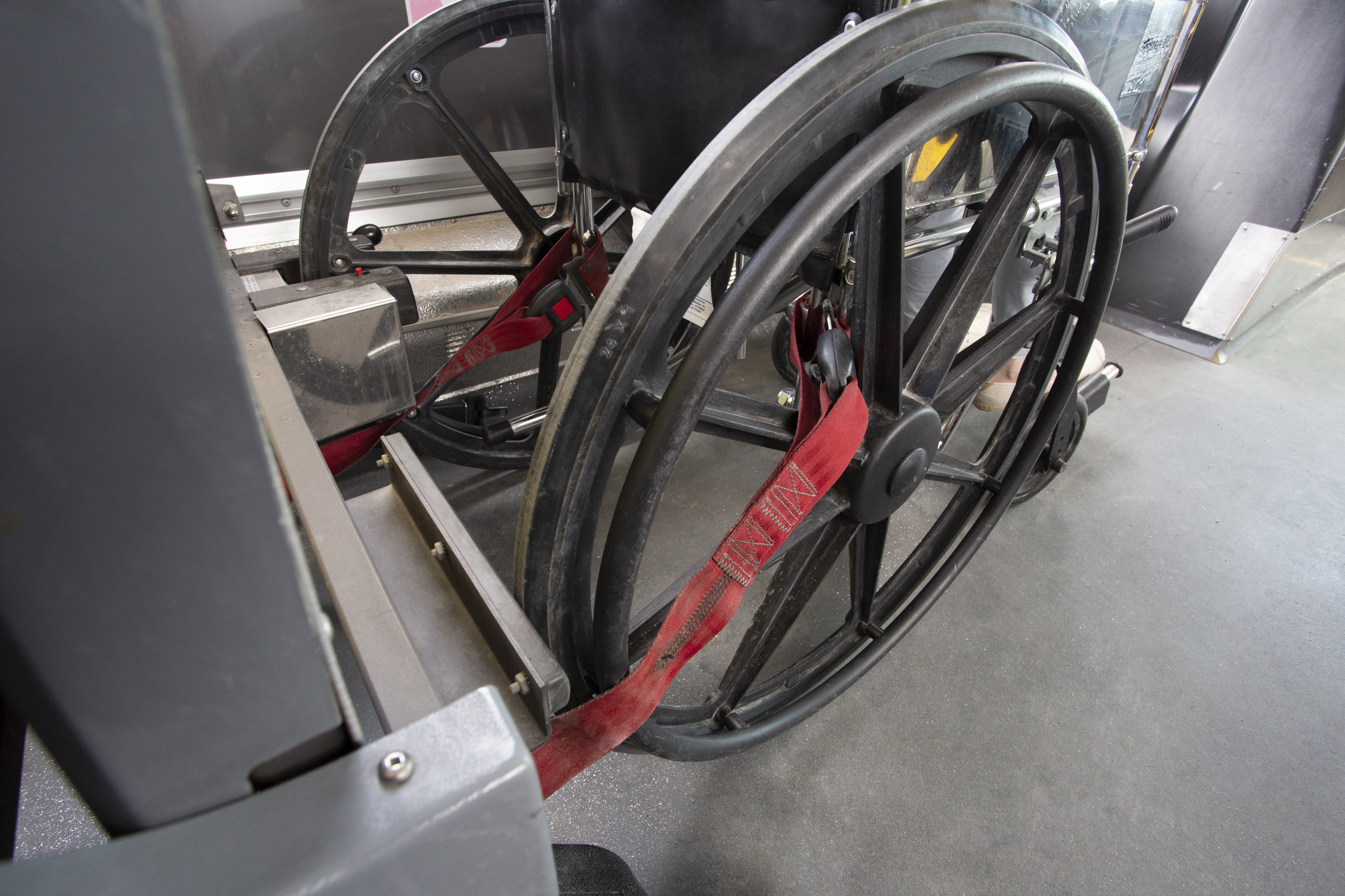 wheelchair using wheel lock and securement belts